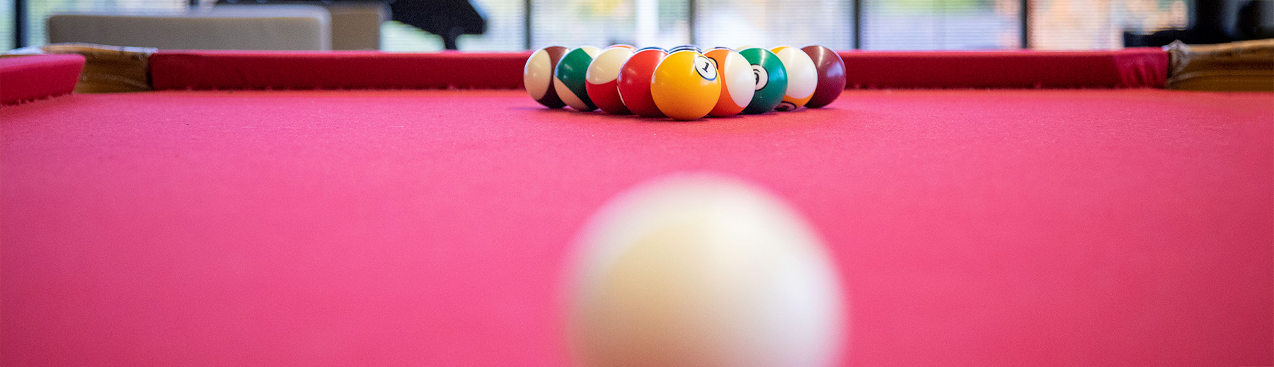 Billiard balls set up on a red billards table