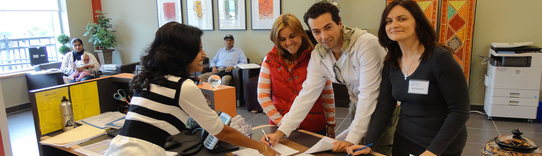 Newcomers register at the reception desk at the Ajax Welcome Centre