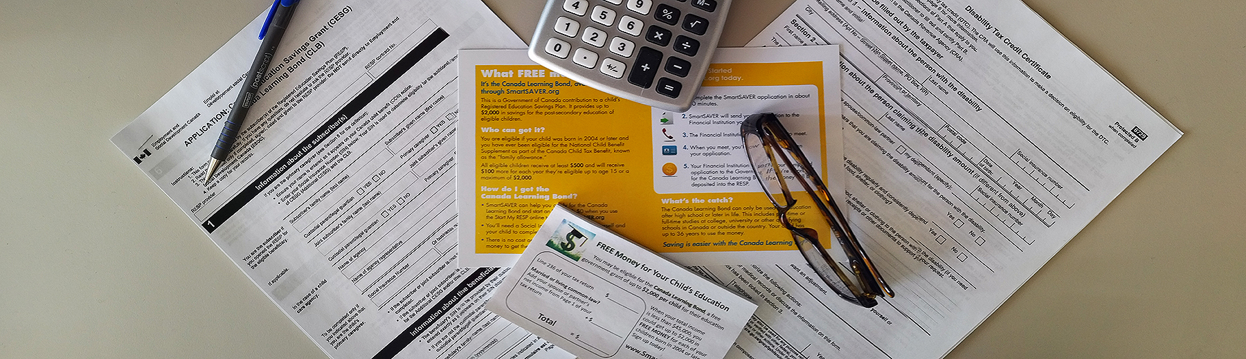 Tax papers on a desk with a calculator