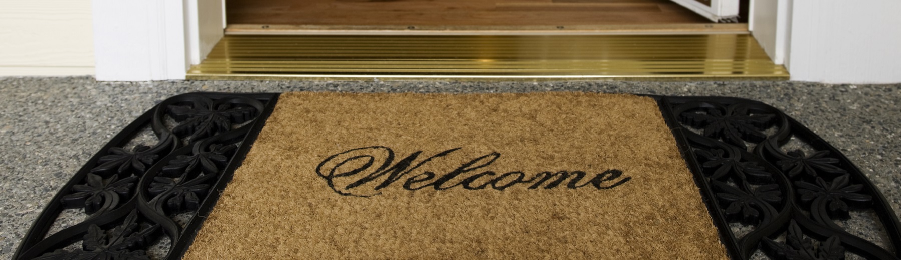 A front door with a welcome mat