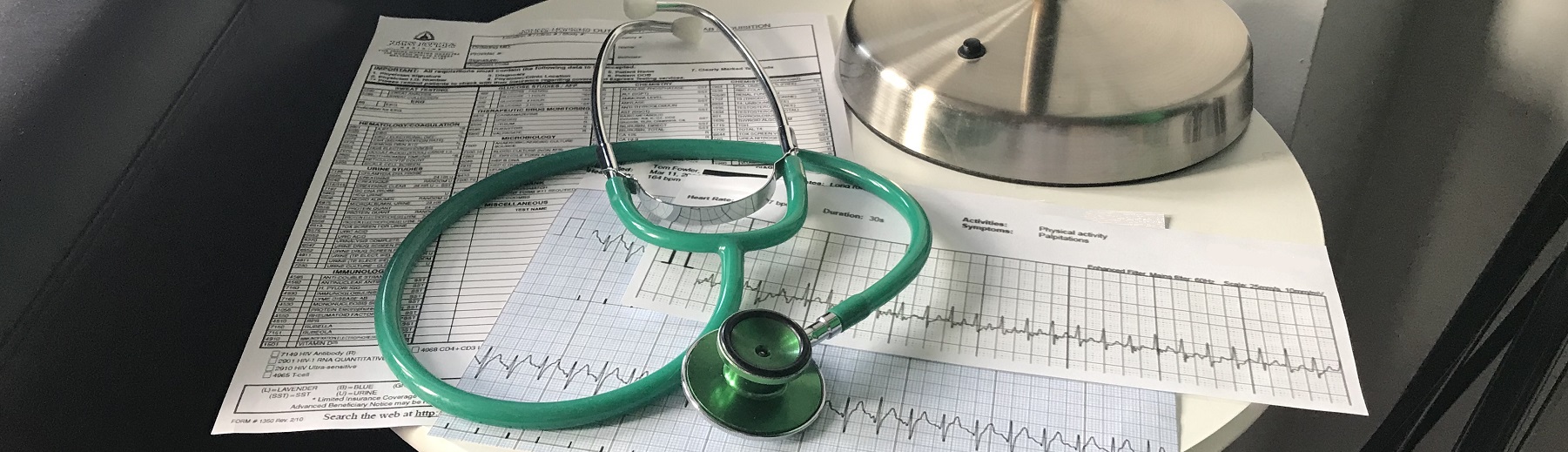 A stethoscope with some heart rate printouts